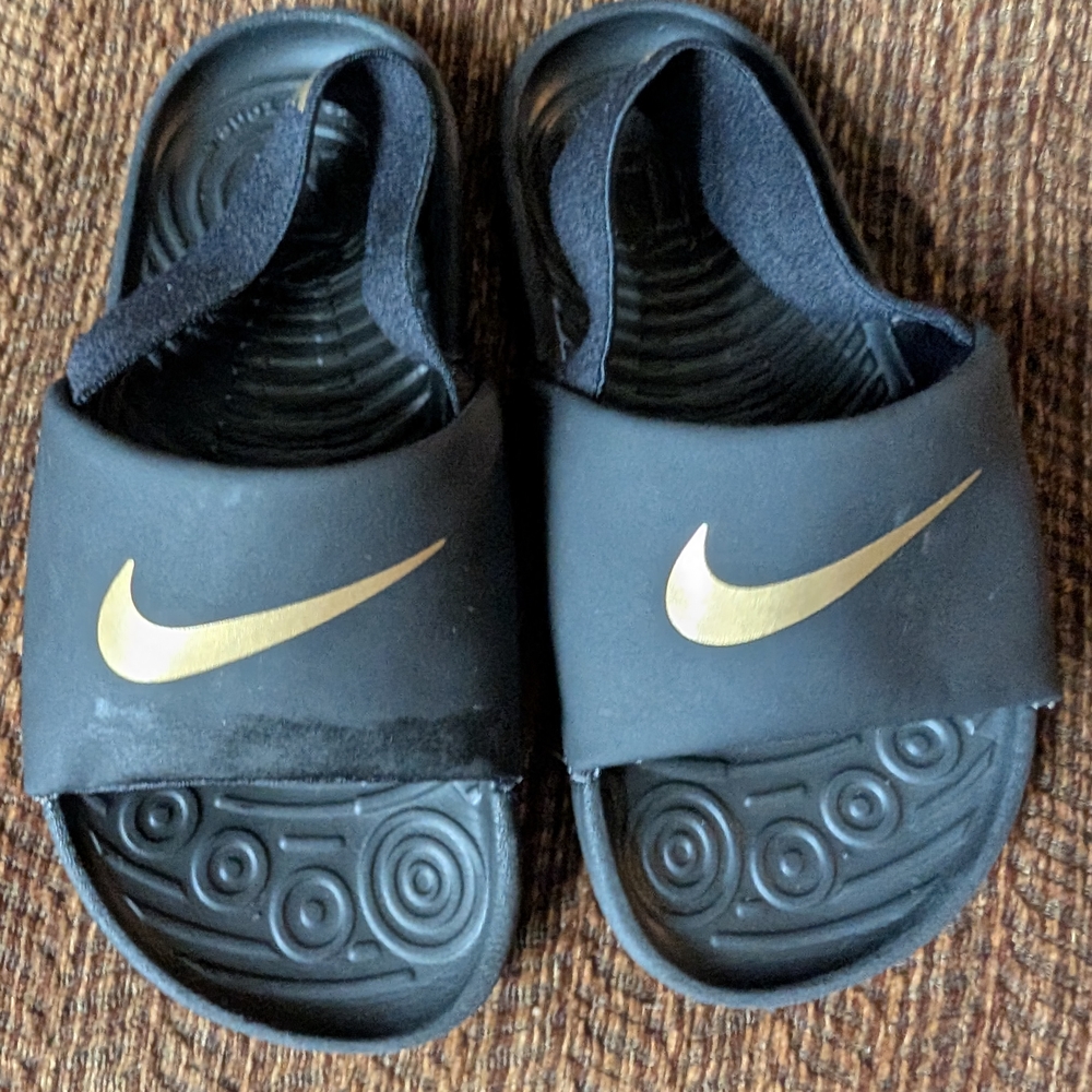 Nike Kids Black Slides with Metallic Gold Swoosh